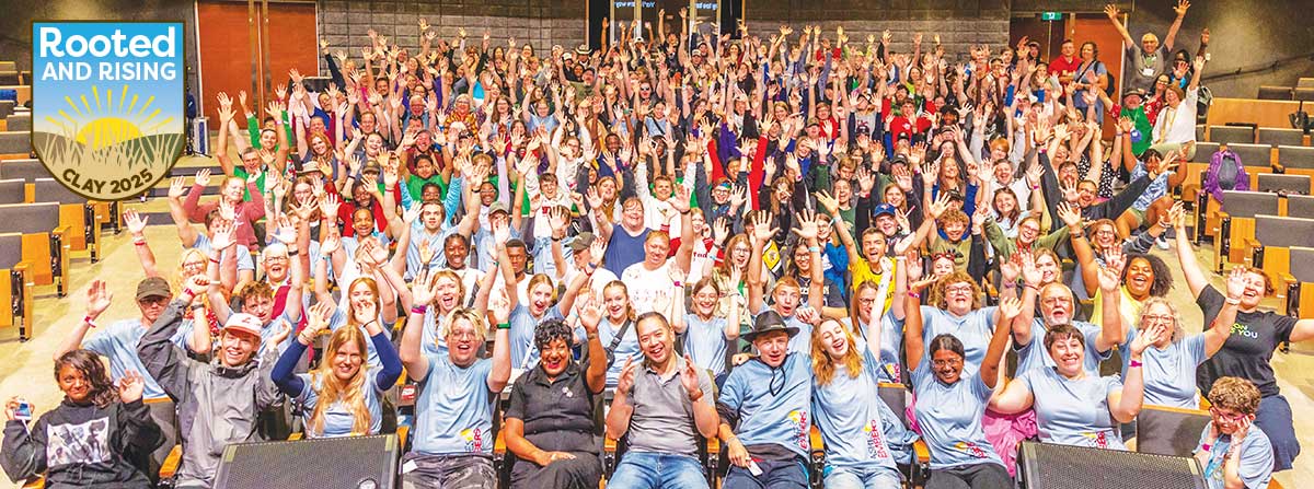 Group of a large number of young people cheering and smiling