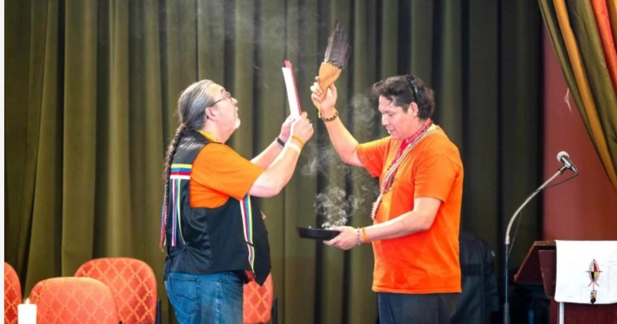 Harper, left, and Steven Seegerts smudge and bless the Covenant and Our Way of Life after the documents were ratified by Sacred Circle May 30, 2023. Photo: Anglican Video